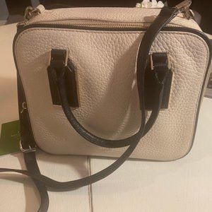 Kate Spade Rectangle Pale Pink Pebbled Leather with Black Trim.